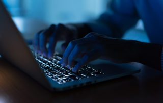 cyber-attacks-person-in-low-light-at-computer