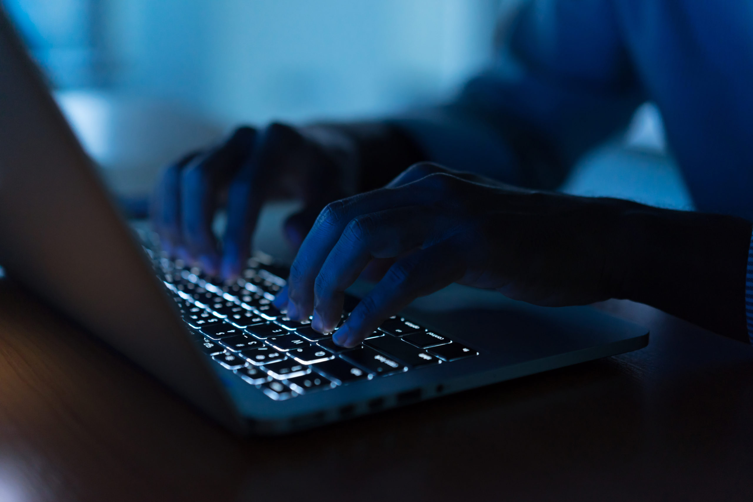 cyber-attacks-person-in-low-light-at-computer