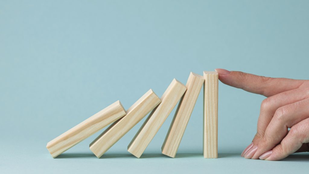 understanding business management risk can prevent the wooden blocks from falling over