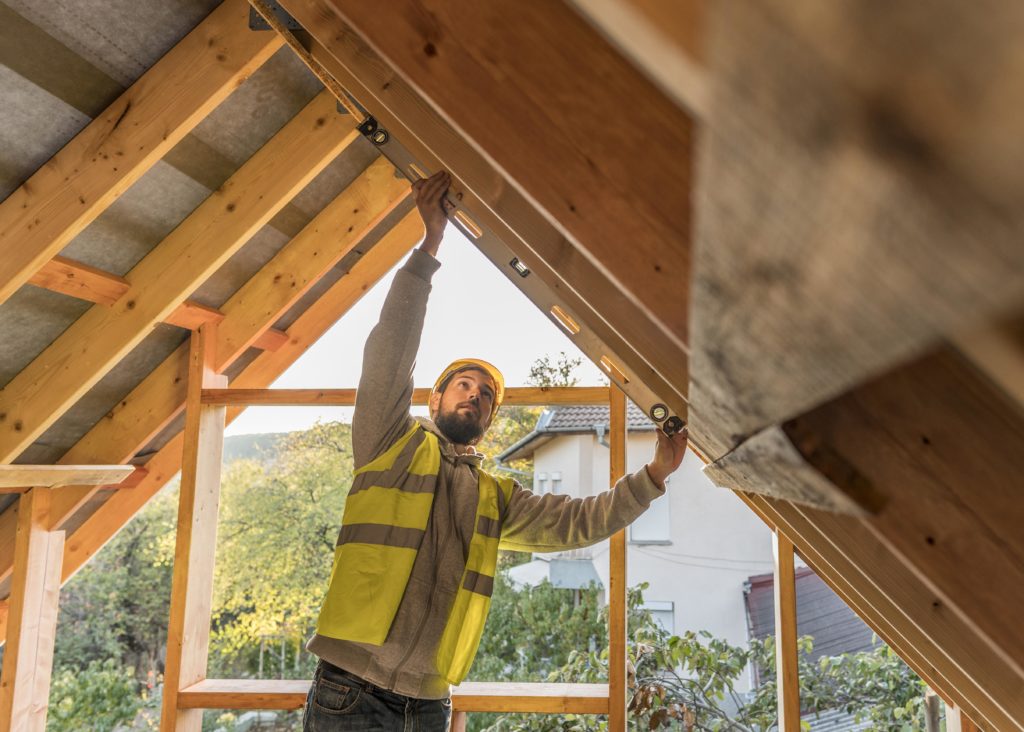 carpenter-man-reparing-roof-expensive-labour-costs-affect-property-insurance-premiums