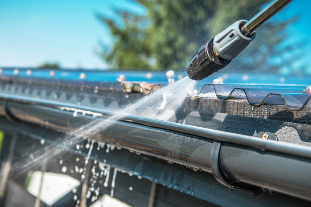 Getting building ready for summer by cleaning gutters.