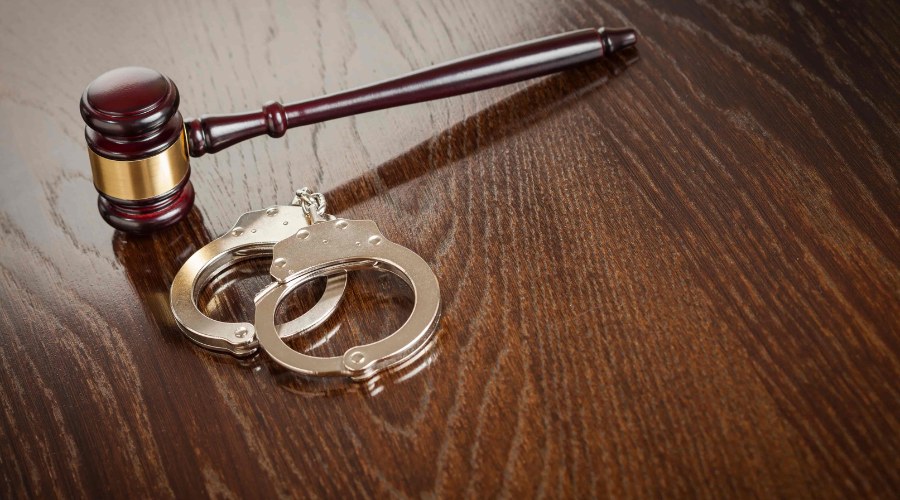 Image of Handcuffs and Gavel for Clear Insurance Blog on Crisis Preparedness for Clubs: Understanding Your Coverage After Violent Incidents