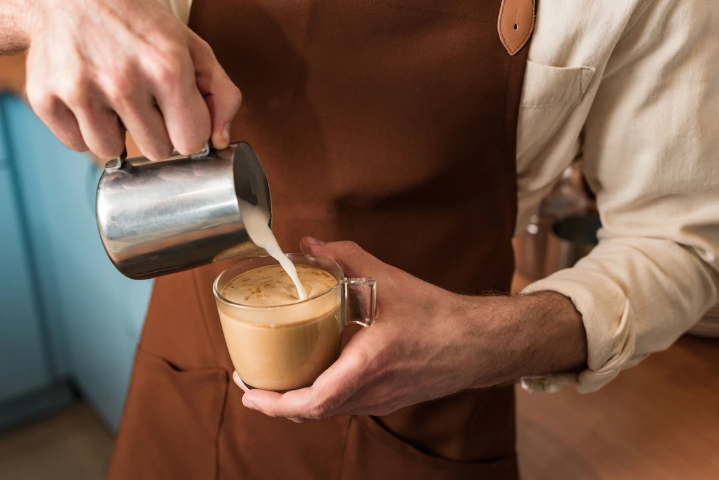 Barista pouring coffee