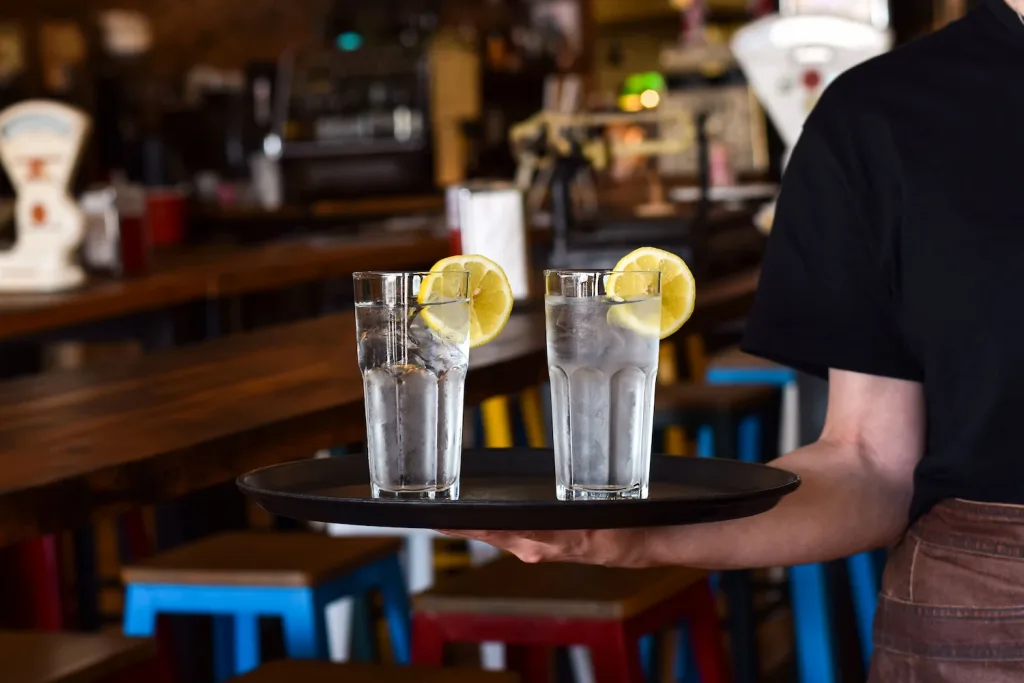 Restaurant drink service - waiter carrying a tray of drinks.