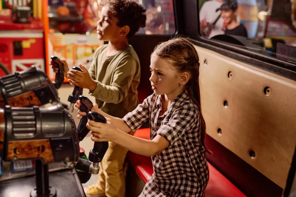 Children playing arcade games in a child safe environment